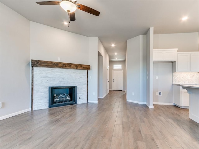 8617 NW 77th St, Oklahoma City, OK 73132 - unfurnished living room with a ceiling fan, light wood finished floors, a fireplace, recessed lighting, and baseboards