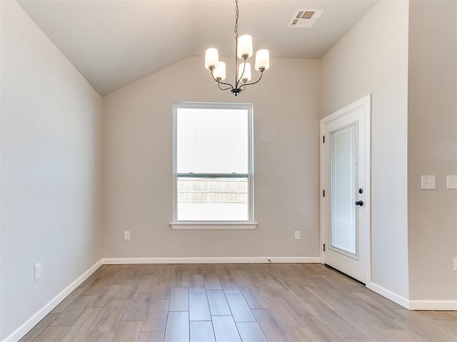 8617 NW 77th St, Oklahoma City, OK 73132 - unfurnished dining area featuring a chandelier, healthy amount of natural light, wood finished floors, vaulted ceiling, and baseboards