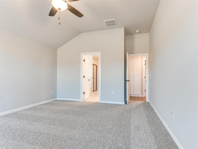 8617 NW 77th St, Oklahoma City, OK 73132 - unfurnished bedroom featuring light carpet, vaulted ceiling, baseboards, a ceiling fan, and connected bathroom