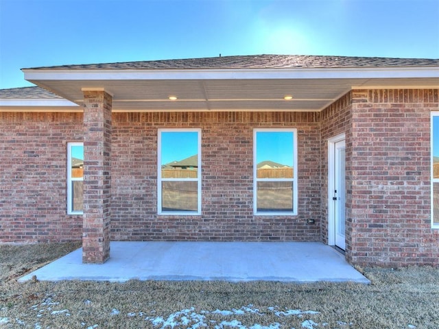 8617 NW 77th St, Oklahoma City, OK 73132 - view of exterior entry with a patio and brick siding