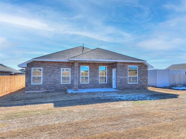8617 NW 77th St, Oklahoma City, OK 73132 - rear view of house featuring brick siding, a patio, and roof with shingles
