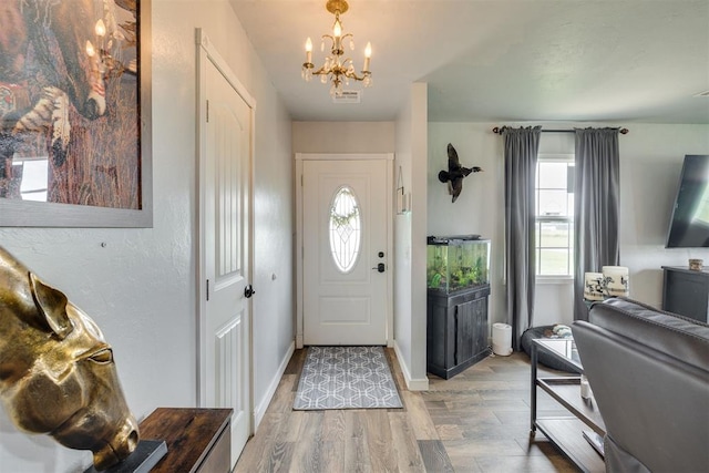 2316 E 68th St, Stillwater, OK 74074 - foyer entrance featuring a chandelier, light wood-style floors, and baseboards