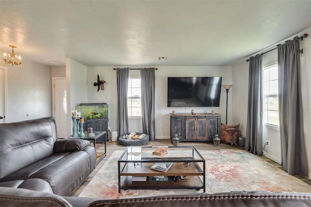 2316 E 68th St, Stillwater, OK 74074 - living room featuring plenty of natural light, a chandelier, and baseboards
