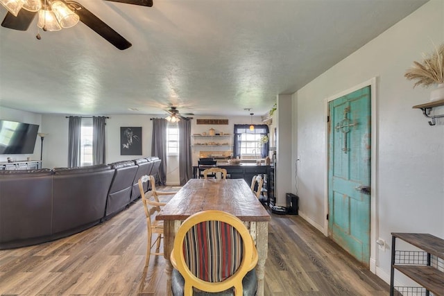 2316 E 68th St, Stillwater, OK 74074 - dining room featuring a ceiling fan, wood finished floors, and baseboards