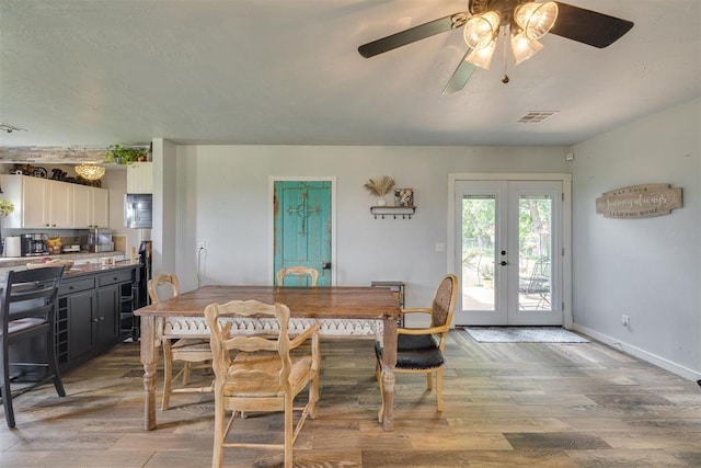 2316 E 68th St, Stillwater, OK 74074 - dining area featuring french doors, light wood-type flooring, ceiling fan, and baseboards