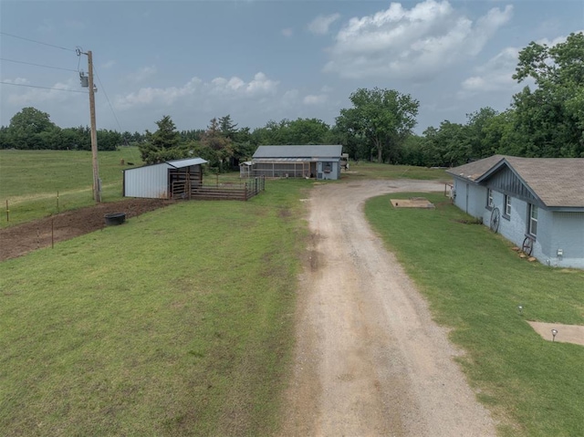 2316 E 68th St, Stillwater, OK 74074 - view of front of property featuring an outbuilding, driveway, an outdoor structure, and a rural view