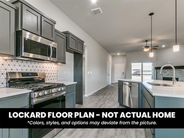 8609 NW 76th St, Oklahoma City, OK 73132 - kitchen with stainless steel appliances, a sink, backsplash, ceiling fan, and light wood finished floors