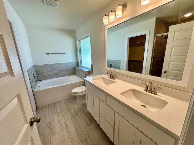 8609 NW 76th St, Oklahoma City, OK 73132 - bathroom with a garden tub, double vanity, a stall shower, and toilet