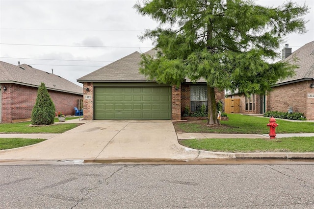 1312 SW 25th St, Moore, OK 73170 - view of front facade featuring an attached garage, brick siding, concrete driveway, a front yard, and roof with shingles