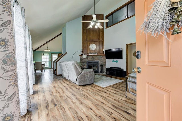 1312 SW 25th St, Moore, OK 73170 - living area featuring wood finished floors, ceiling fan, high vaulted ceiling, and a stone fireplace