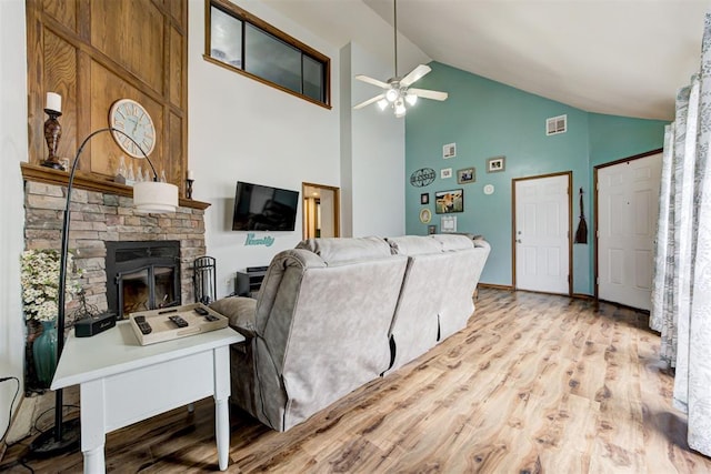 1312 SW 25th St, Moore, OK 73170 - living room with ceiling fan, high vaulted ceiling, light wood-type flooring, and a stone fireplace