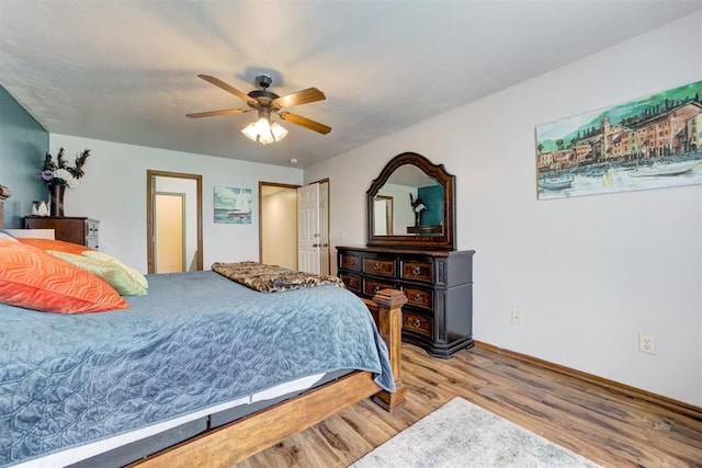 1312 SW 25th St, Moore, OK 73170 - bedroom with wood finished floors, baseboards, and a ceiling fan