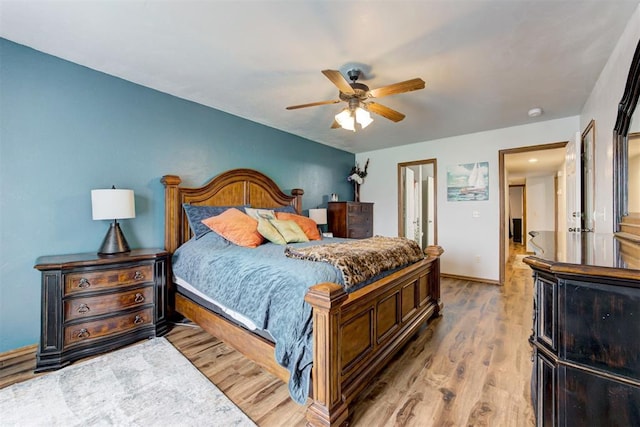 1312 SW 25th St, Moore, OK 73170 - bedroom with wood finished floors, a ceiling fan, and baseboards