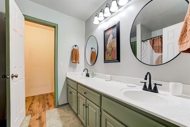 1312 SW 25th St, Moore, OK 73170 - bathroom featuring double vanity and wood finished floors
