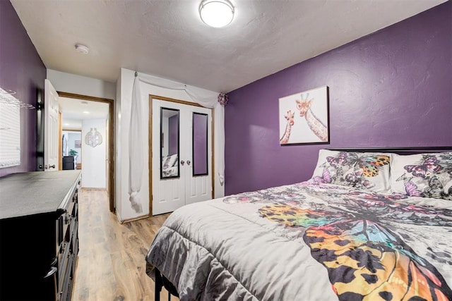 1312 SW 25th St, Moore, OK 73170 - bedroom with light wood finished floors and a closet