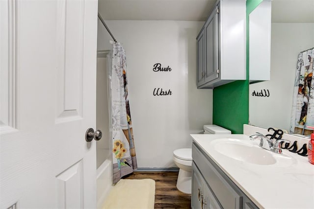 1312 SW 25th St, Moore, OK 73170 - full bathroom featuring vanity, wood finished floors, toilet, and shower / tub combo with curtain