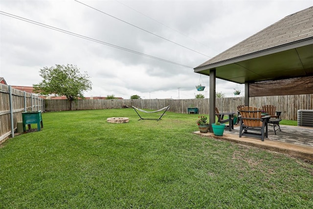1312 SW 25th St, Moore, OK 73170 - view of yard featuring central air condition unit, a patio, and an outdoor fire pit