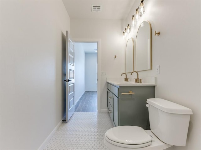 2812 Shoreridge Ave Unit 2812, Norman, OK 73072 - bathroom featuring toilet, vanity, and baseboards