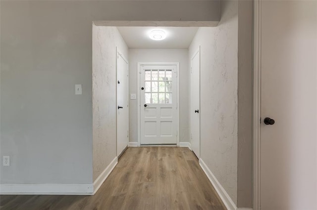 2424 Ashley Dr, The Village, OK 73120 - doorway to outside featuring wood finished floors and baseboards