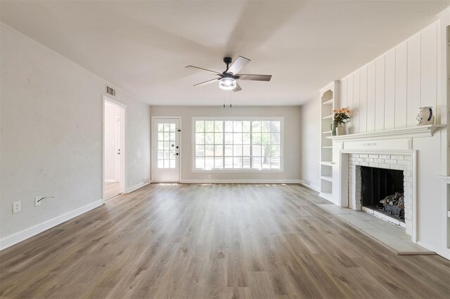 2424 Ashley Dr, The Village, OK 73120 - unfurnished living room with a ceiling fan, wood finished floors, baseboards, a fireplace, and built in features