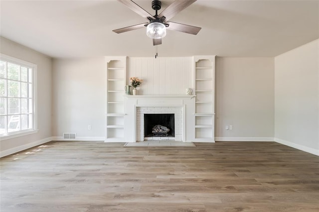 2424 Ashley Dr, The Village, OK 73120 - unfurnished living room featuring ceiling fan, baseboards, wood finished floors, and a fireplace