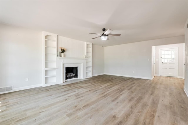 2424 Ashley Dr, The Village, OK 73120 - unfurnished living room with a ceiling fan, baseboards, and built in features