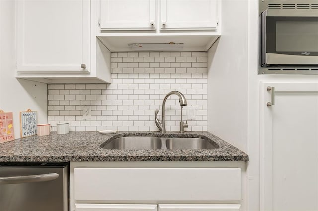2424 Ashley Dr, The Village, OK 73120 - kitchen with stainless steel appliances, a sink, white cabinets, and backsplash