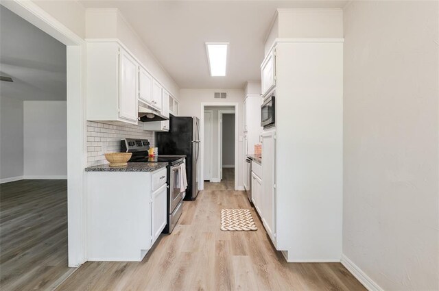 2424 Ashley Dr, The Village, OK 73120 - kitchen featuring stainless steel appliances, under cabinet range hood, light wood finished floors, white cabinetry, and tasteful backsplash