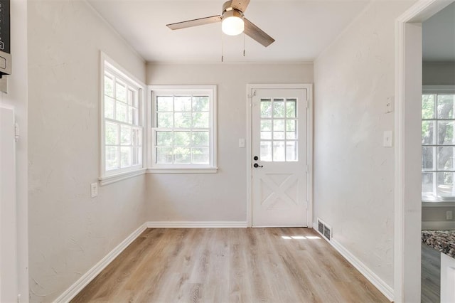 2424 Ashley Dr, The Village, OK 73120 - doorway to outside featuring healthy amount of natural light, light wood-style floors, a ceiling fan, and baseboards