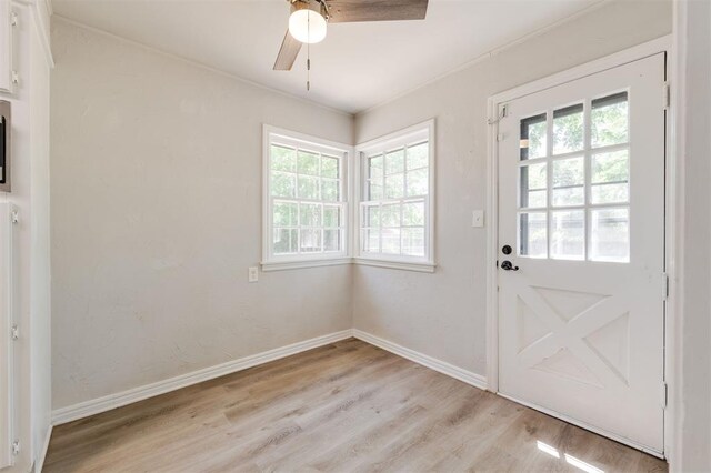 2424 Ashley Dr, The Village, OK 73120 - doorway with healthy amount of natural light, light wood finished floors, a ceiling fan, and baseboards