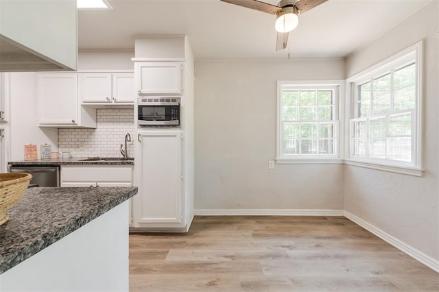 2424 Ashley Dr, The Village, OK 73120 - kitchen featuring appliances with stainless steel finishes, decorative backsplash, white cabinets, dark stone countertops, and light wood-type flooring