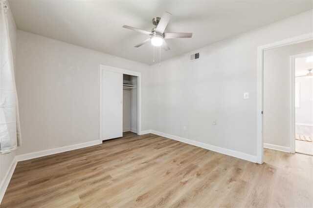 2424 Ashley Dr, The Village, OK 73120 - unfurnished bedroom featuring light wood-style floors, baseboards, a closet, and ceiling fan