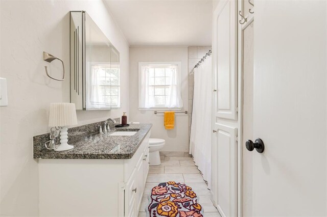2424 Ashley Dr, The Village, OK 73120 - full bathroom featuring toilet, vanity, a shower with curtain, and tile patterned floors