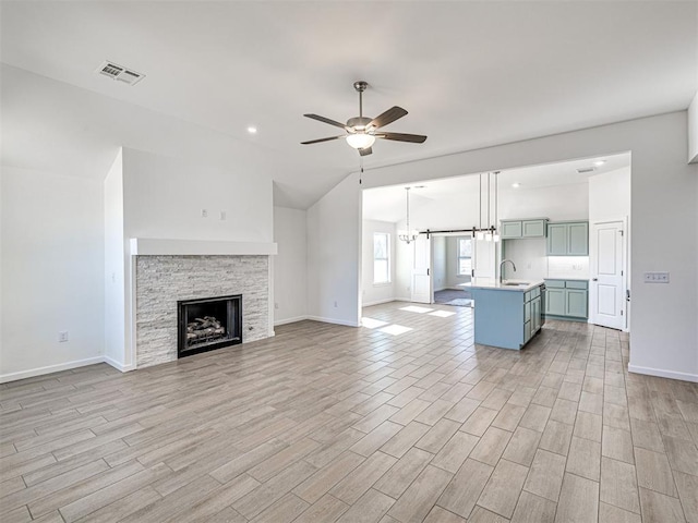 1121 Acacia Creek Dr, Yukon, OK 73099 - unfurnished living room with a ceiling fan, light wood-style flooring, baseboards, vaulted ceiling, and recessed lighting