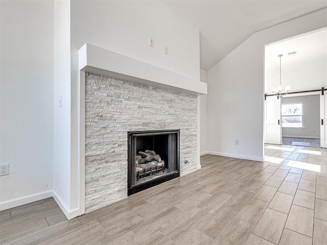 1121 Acacia Creek Dr, Yukon, OK 73099 - unfurnished living room with vaulted ceiling, wood finished floors, a chandelier, a fireplace, and baseboards