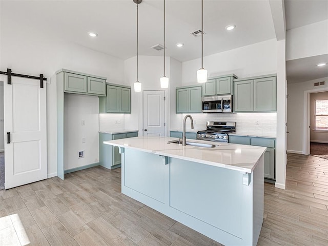 1121 Acacia Creek Dr, Yukon, OK 73099 - kitchen featuring appliances with stainless steel finishes, a sink, decorative backsplash, light wood finished floors, and light countertops