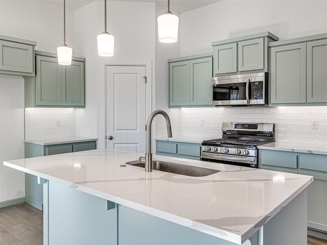 1121 Acacia Creek Dr, Yukon, OK 73099 - kitchen with appliances with stainless steel finishes, a sink, light stone countertops, decorative backsplash, and decorative light fixtures