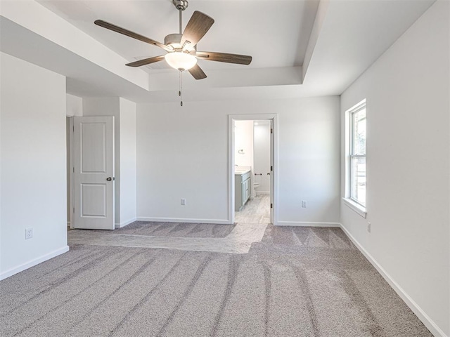 1121 Acacia Creek Dr, Yukon, OK 73099 - unfurnished room with a tray ceiling, a ceiling fan, light carpet, and baseboards
