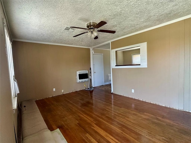 1137 E Chestnut St, Altus, OK 73521 - spare room featuring heating unit, ceiling fan, wood finished floors, ornamental molding, and a textured ceiling