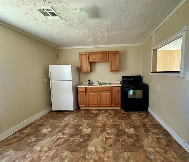 1137 E Chestnut St, Altus, OK 73521 - kitchen featuring freestanding refrigerator, black electric range, baseboards, light countertops, and a sink