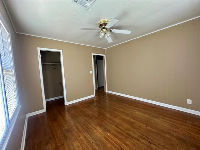1137 E Chestnut St, Altus, OK 73521 - unfurnished bedroom with baseboards, wood-type flooring, ornamental molding, a closet, and a ceiling fan