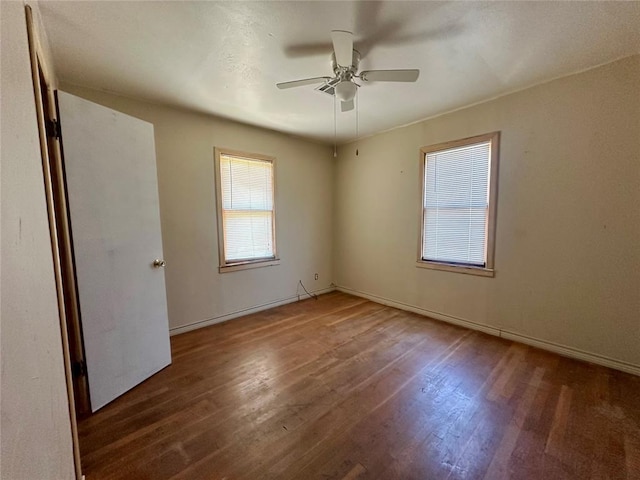1137 E Chestnut St, Altus, OK 73521 - spare room featuring wood finished floors, ceiling fan, and baseboards