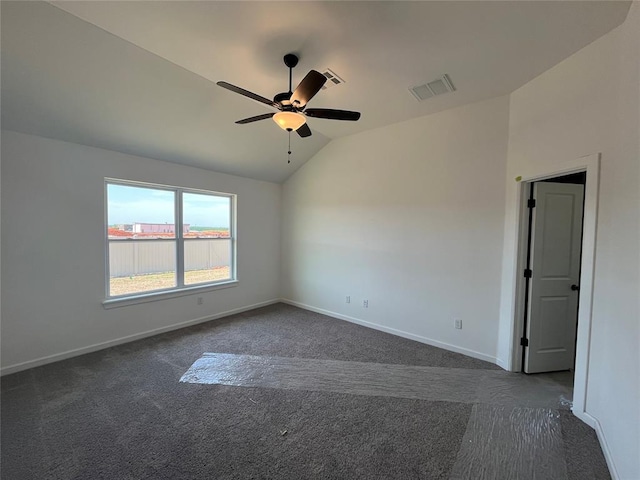 18121 Austin Ct, Edmond, OK 73012 - empty room featuring dark colored carpet, vaulted ceiling, and baseboards
