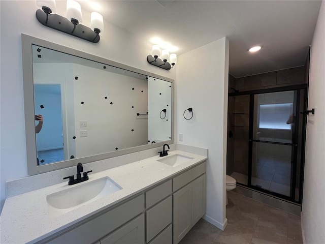 18121 Austin Ct, Edmond, OK 73012 - full bathroom featuring a stall shower, toilet, double vanity, and tile patterned flooring