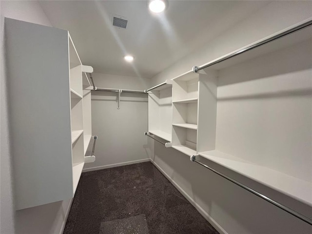 18121 Austin Ct, Edmond, OK 73012 - walk in closet with dark carpet