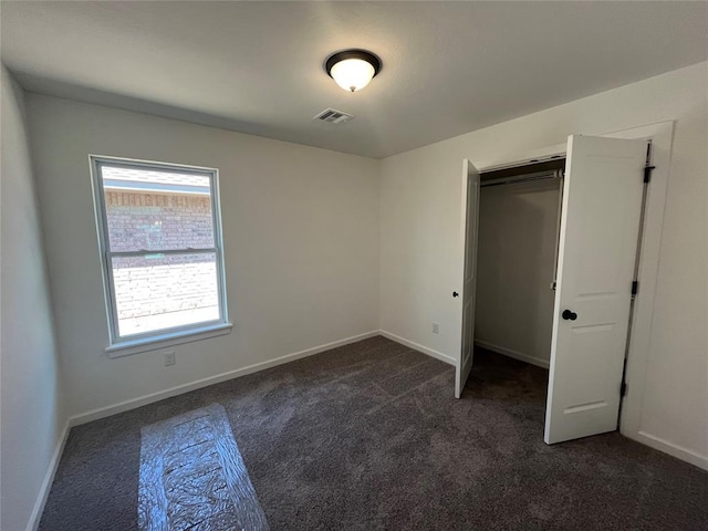18121 Austin Ct, Edmond, OK 73012 - unfurnished bedroom with dark carpet and baseboards