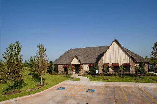 18121 Austin Ct, Edmond, OK 73012 - tudor-style house featuring board and batten siding, uncovered parking, and a front yard