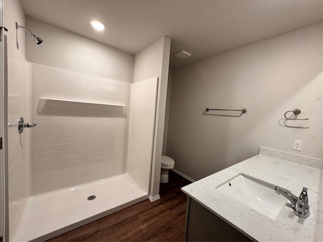 1204 E Stetson Ln, Mustang, OK 73064 - bathroom featuring wood finished floors, toilet, a shower stall, vanity, and recessed lighting