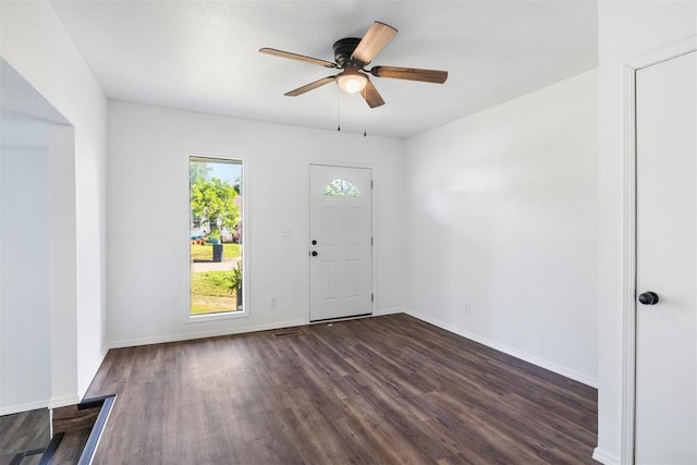foyer entrance featuring dark wood-style floors, a ceiling fan, and baseboards