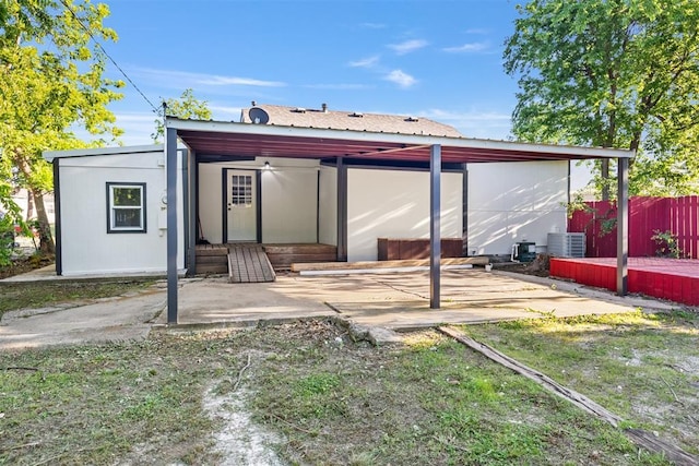 back of house featuring fence and central AC unit